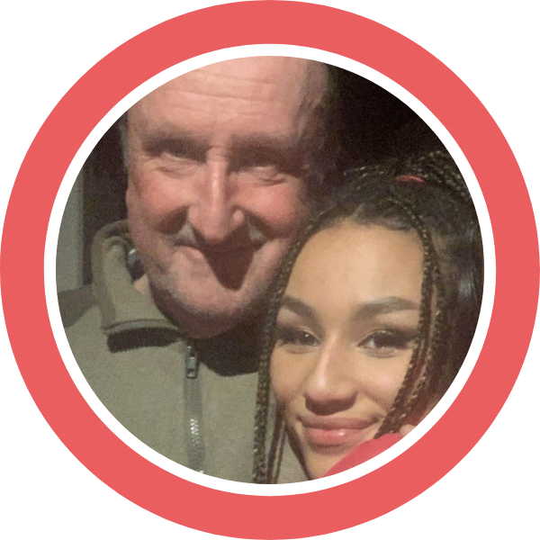 A photo of engineer John with his daughter Fabienne. Both are looking at the camera and smiling.