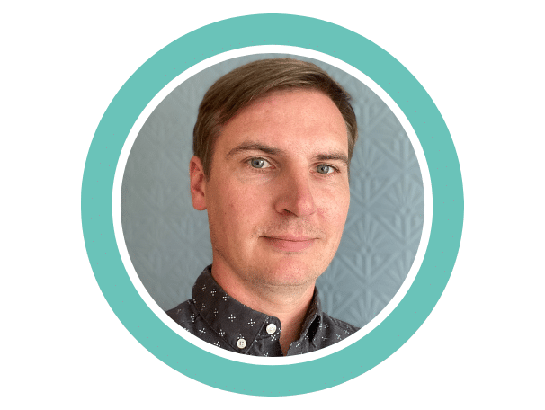 A photo of Jonny Ridge, Head of Fundraising and Communications at Foothold, enclose in a branded Teal ring. Jonny had short brown hair, is looking at the camera and is slightly smiling.
