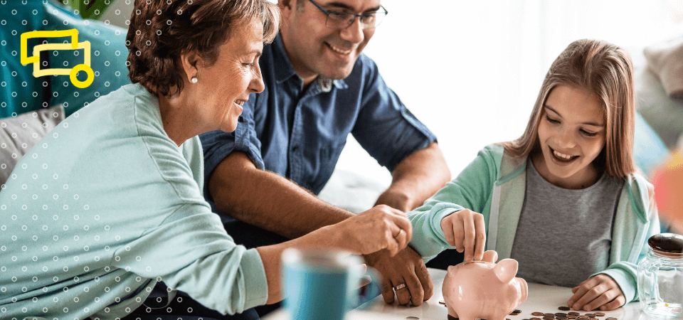 A family puts coins into a piggy bank