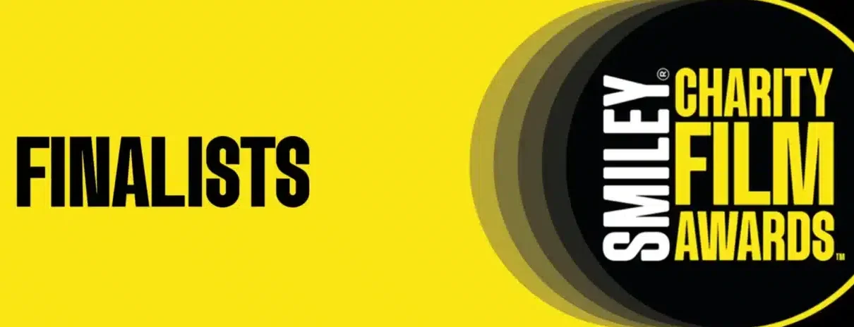 Smiley charity film awards banner in yellow and black with the wording we're 'finalists'